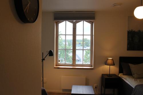 a bedroom with a window and a bed and a lamp at Stekhuset B&B in Kalmar