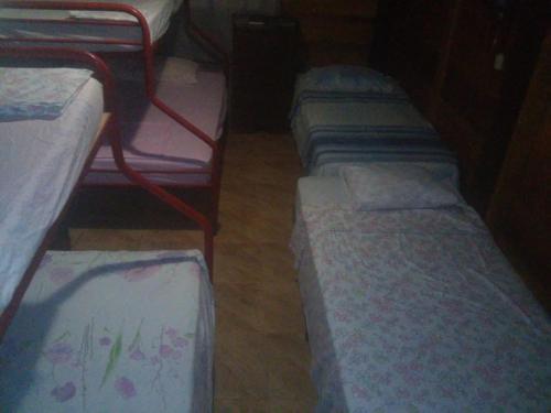 a row of bunk beds in a room at Hostal Villas Mexico in San Juan del Sur