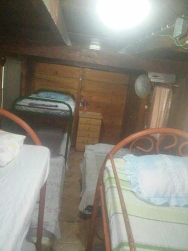a room with two bunk beds in a house at Hostal Villas Mexico in San Juan del Sur