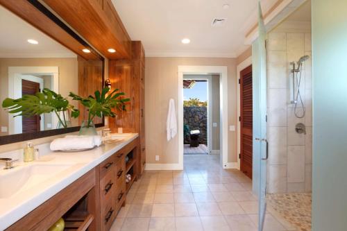 a bathroom with a sink and a shower at The Lodge at Kukuiula - CoralTree Residence Collection in Koloa