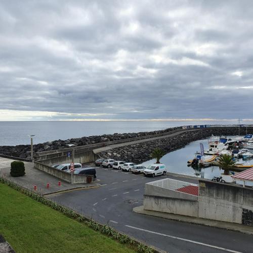 a parking lot with cars parked next to a marina at Black'nYellow Place in Vila Franca do Campo