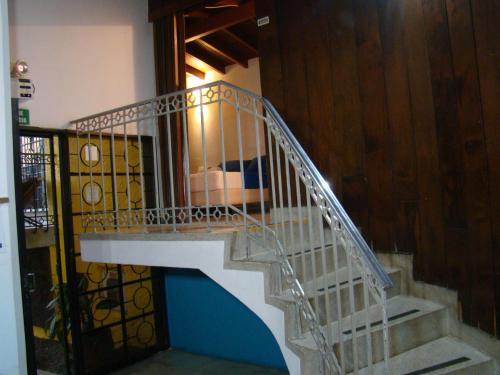 a staircase leading up to a small room at Yellow House Hostel in Medellín