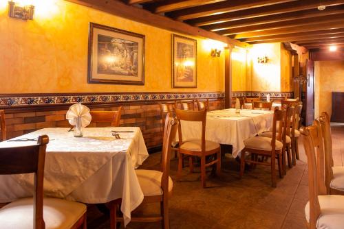 a dining room with tables and chairs and yellow walls at Hotel Principe in Tuluá