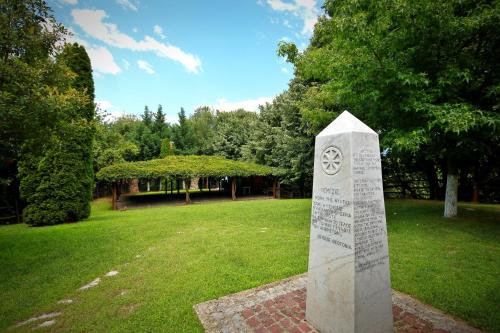 a monument in a park with a building in the background at Hotel Nemesis in Stavroupoli