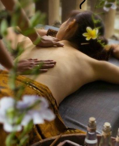 a woman laying on the floor in a massage room at Casa das Rendas in Praia de Moitas