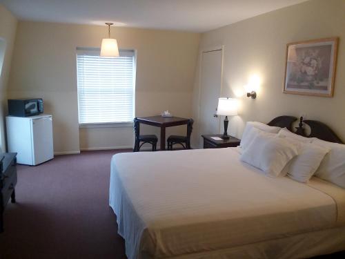 a hotel room with a large bed and a window at Walton Inn in Willard