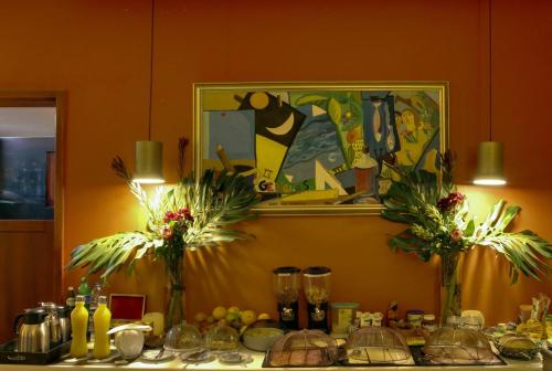 a table with two vases with flowers on it at Dazk Golden Estate in Ribeira Brava
