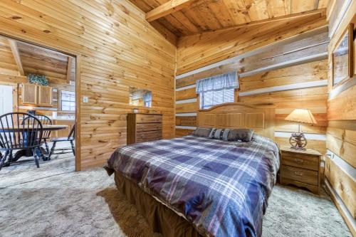 a bedroom with a bed in a log cabin at Almost Heaven in Townsend