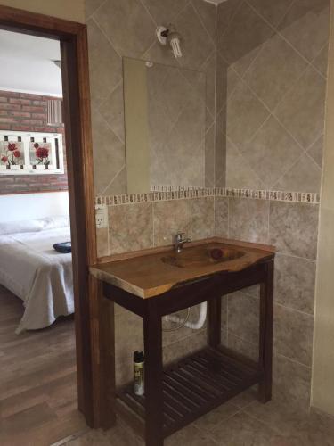 a bathroom with a wooden sink and a mirror at La Posada del Hobbit in Villa Ventana