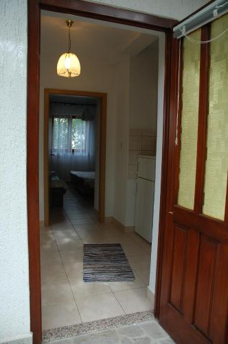 a hallway with a door leading to a kitchen at Apartments Jurina in Krk