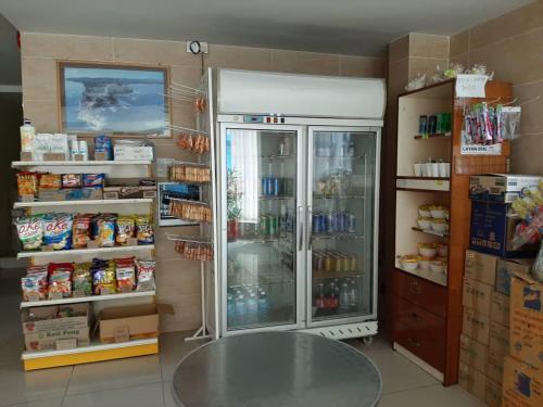 a room with a refrigerator and a table in it at Hotel Oriental in Inanam
