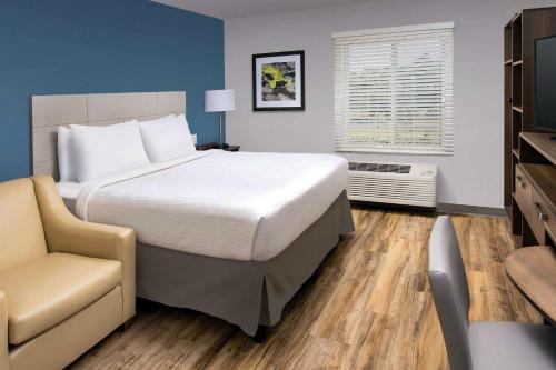 A bed or beds in a room at Woodspring Suites Cherry Hill