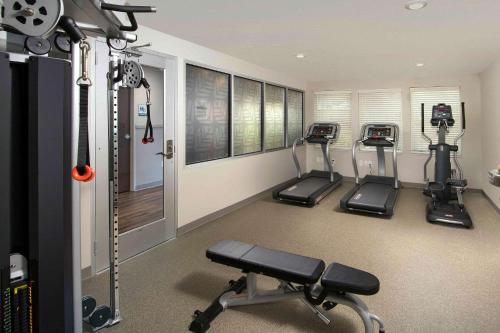 a gym with three treadmills in a room at Woodspring Suites Cherry Hill in Cherry Hill