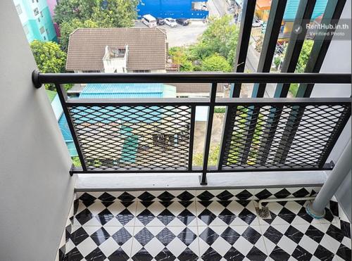 a balcony with a black and white checkered floor at The Diamond 789 Minburi in Bangkok