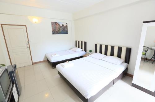 a bedroom with two beds in a room at sk resort in Bangkok