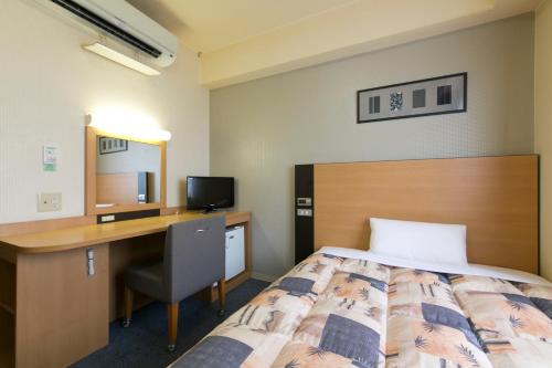 Ένα ή περισσότερα κρεβάτια σε δωμάτιο στο Hotel Econo Taki