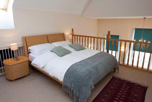 a bedroom with a large bed and a balcony at Kilchoman in Port Charlotte