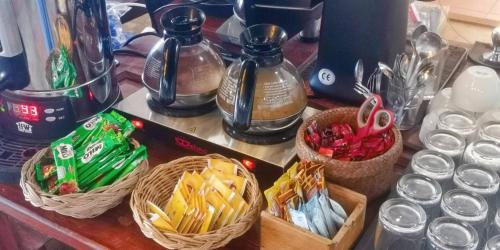 a counter top with baskets of chips and bottles at Koh Mak Resort in Ko Mak