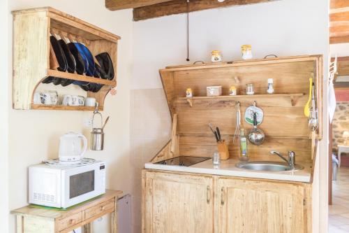 a kitchen with a sink and a microwave at Agriturismo di là dall'Acqua in Fivizzano