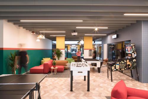 a lobby with couches and a ping pong table at ROXI The Urban Residence Brussels in Brussels