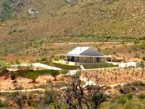 a large white house in the middle of a field at Robertson Stays in Robertson