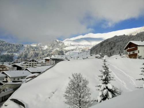 a view of a snow covered town in a mountain at Hotel Garni Alpendiamant in Fiss