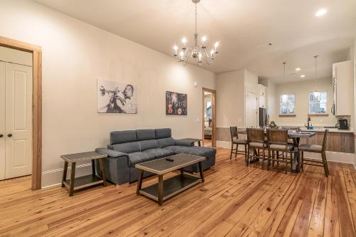 a living room with a couch and a table at Fabulous Cottages with City Views in New Orleans
