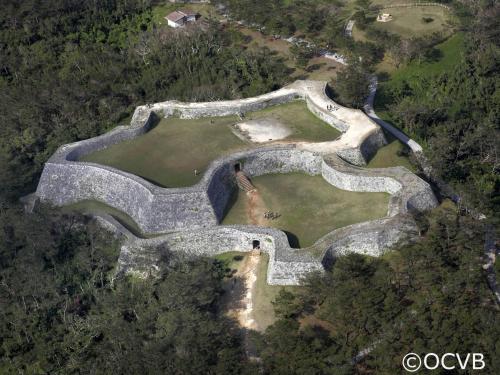 an aerial view of an ancient castle in the forest at Yomitan Condhotel ND in Yomitan