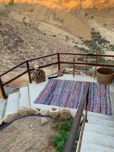 a table with a rug next to a fence at אוהל לוט in Arad