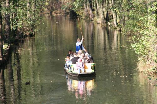 a group of people in a boat on a river at "Spreehof" Apartmenthaus in Lehde in Lübbenau
