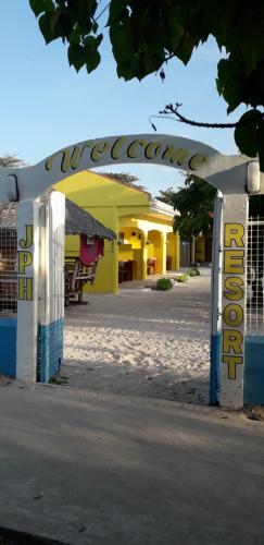 a gate with a sign in front of a building at JPH Resort in Malapascua Island