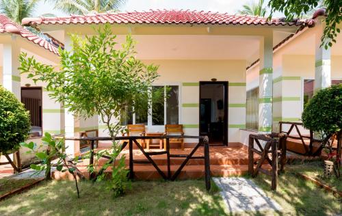 a house with a table in front of it at Trung Huynh Bungalow in Phu Quoc