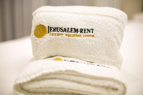 a roll of toilet paper sitting on top of a sink at 108 - King David Residence - Jerusalem-Rent in Jerusalem