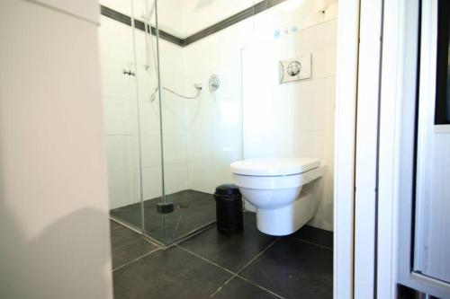 a bathroom with a toilet and a glass shower at 202 - King David Residence - Jerusalem-Rent in Jerusalem