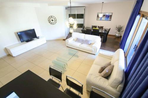 a living room with two white couches and a television at 202 - King David Residence - Jerusalem-Rent in Jerusalem