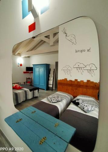 a mirror in a room with two beds at B&B Madonna degli Airali in Vezza d'Alba