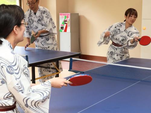 a group of people playing table tennis at Hotel Miki in Gero