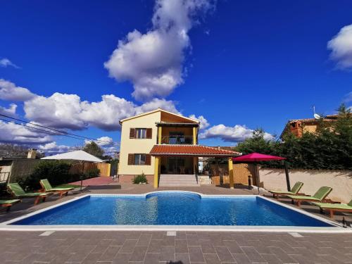 a villa with a swimming pool in front of a house at House ANA - Loborika, Pula, 4 bedrooms in Loborika
