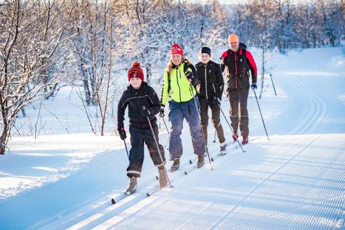 a group of people on skis in the snow at Hotell Bruksvallsliden in Bruksvallarna
