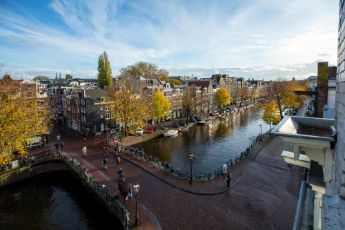 a view of a city with a river and buildings at Amsterdam Wiechmann Hotel in Amsterdam