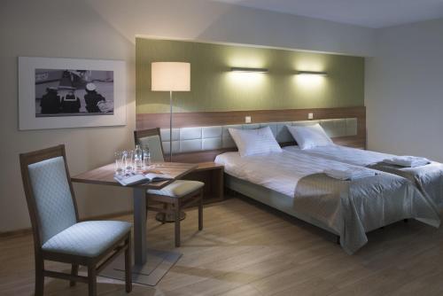 Un pat sau paturi într-o cameră la Olymp 3