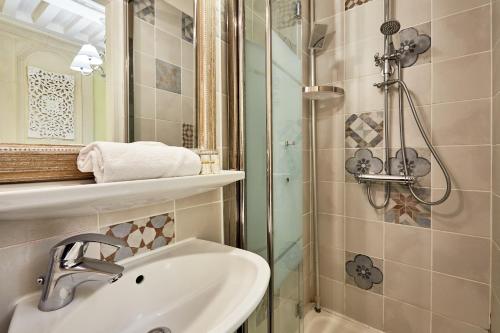 a bathroom with a sink and a shower at Hotel Saint Etienne in Caen