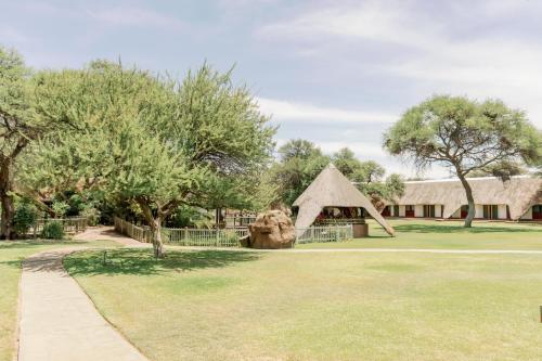 a view of a building with a grass yard at Okahandja Country Hotel in Okahandja