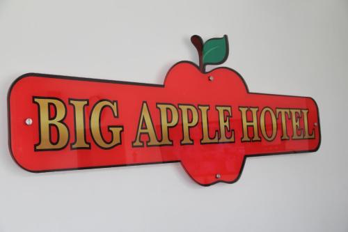 a big apple hotel sign with an apple on it at Big Apple Hotel in Kulim