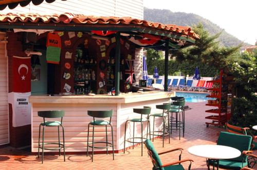 
a patio area with tables, chairs and umbrellas at Avlu 4 in Marmaris
