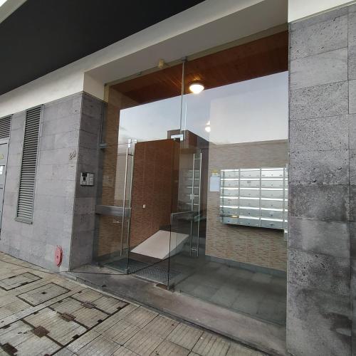 a bathroom with a glass shower in a building at Apartamento Solmar in Ponta Delgada