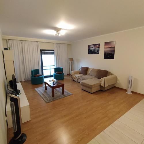 a living room with a couch and a table at Apartamento Solmar in Ponta Delgada