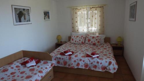 a bedroom with two beds and a window at Luštica Apartments in Lustica
