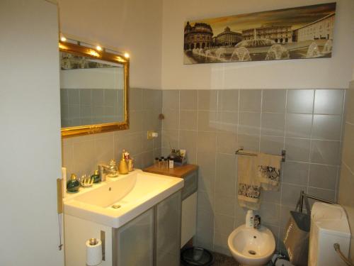 a bathroom with a sink and a toilet at Doria House 23 in Genoa