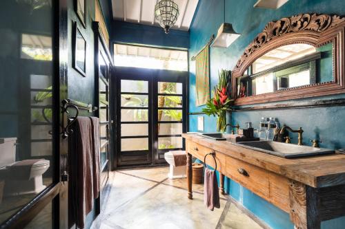 a bathroom with a sink and a mirror at 11 on Kajeng in Ubud